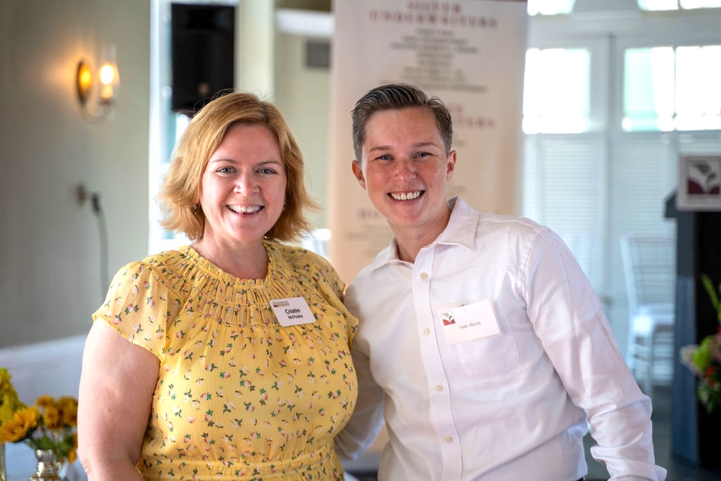 two smiling people standing together
