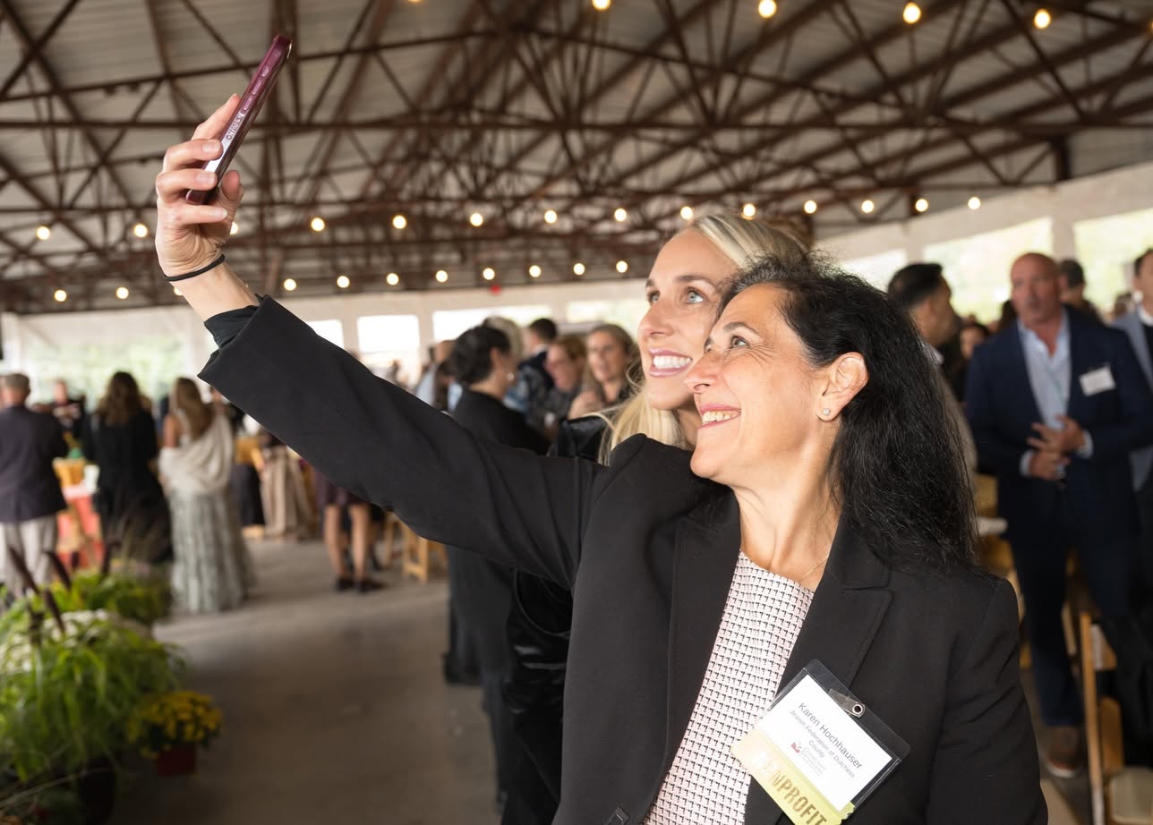 people taking selfie at event